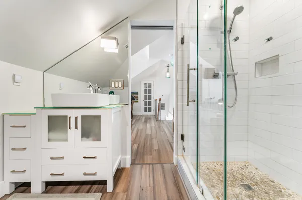 a view of a hallway with wooden floor and glass door