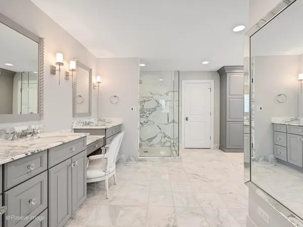 a bathroom with a granite countertop sink mirror and shower
