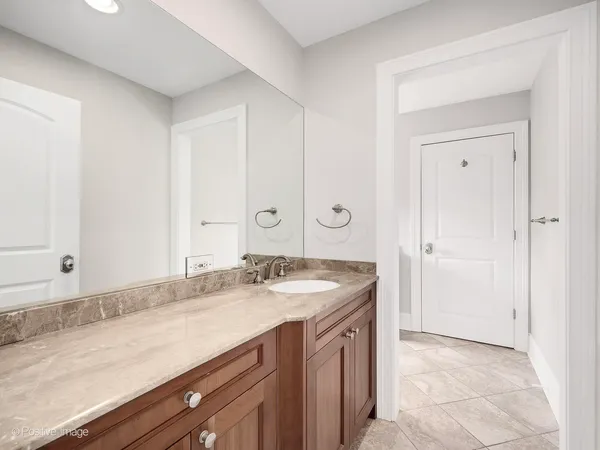 a bathroom with a granite countertop sink and a mirror