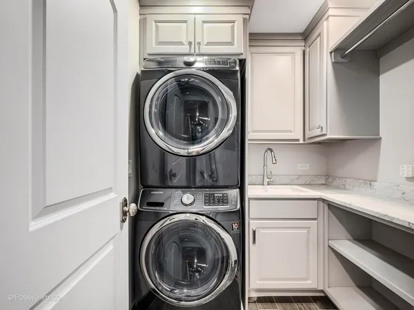 a utility room with sink dryer and washer