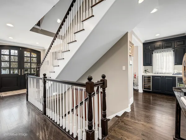 a view of front door wooden floor and a kitchen