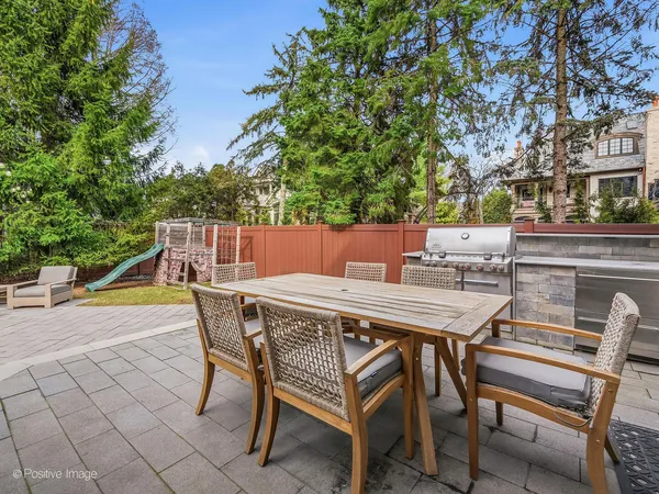 a patio with dining table and chairs