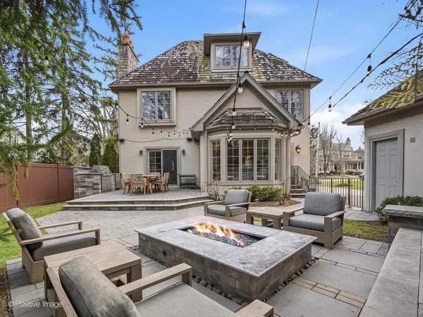 a view of a patio with couches table and chairs with wooden floor