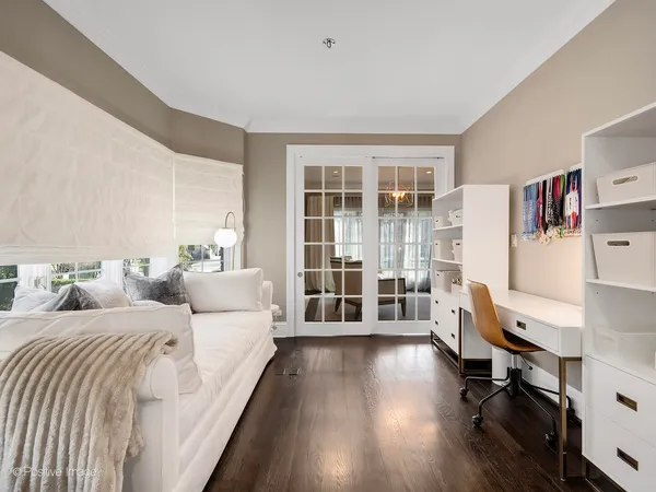 a large bedroom with bed and a large window
