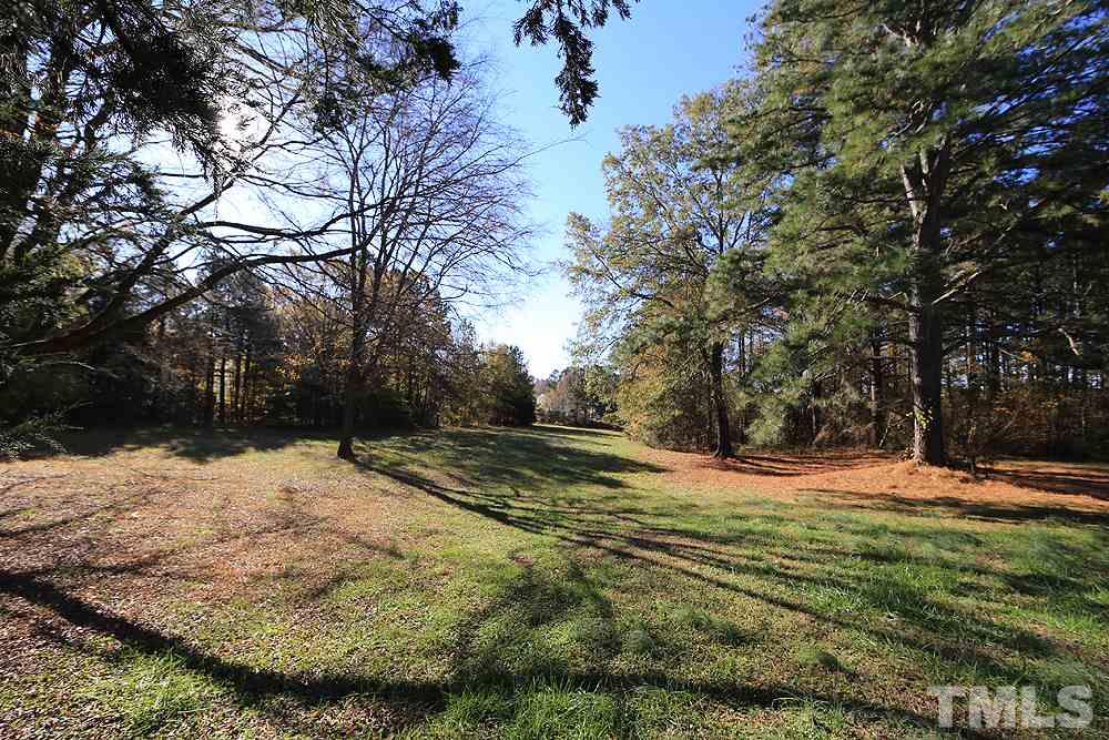 3801 Pearl Road Raleigh, NC 27610 - Photo 6 of 13 a view of dirt yard with a large tree