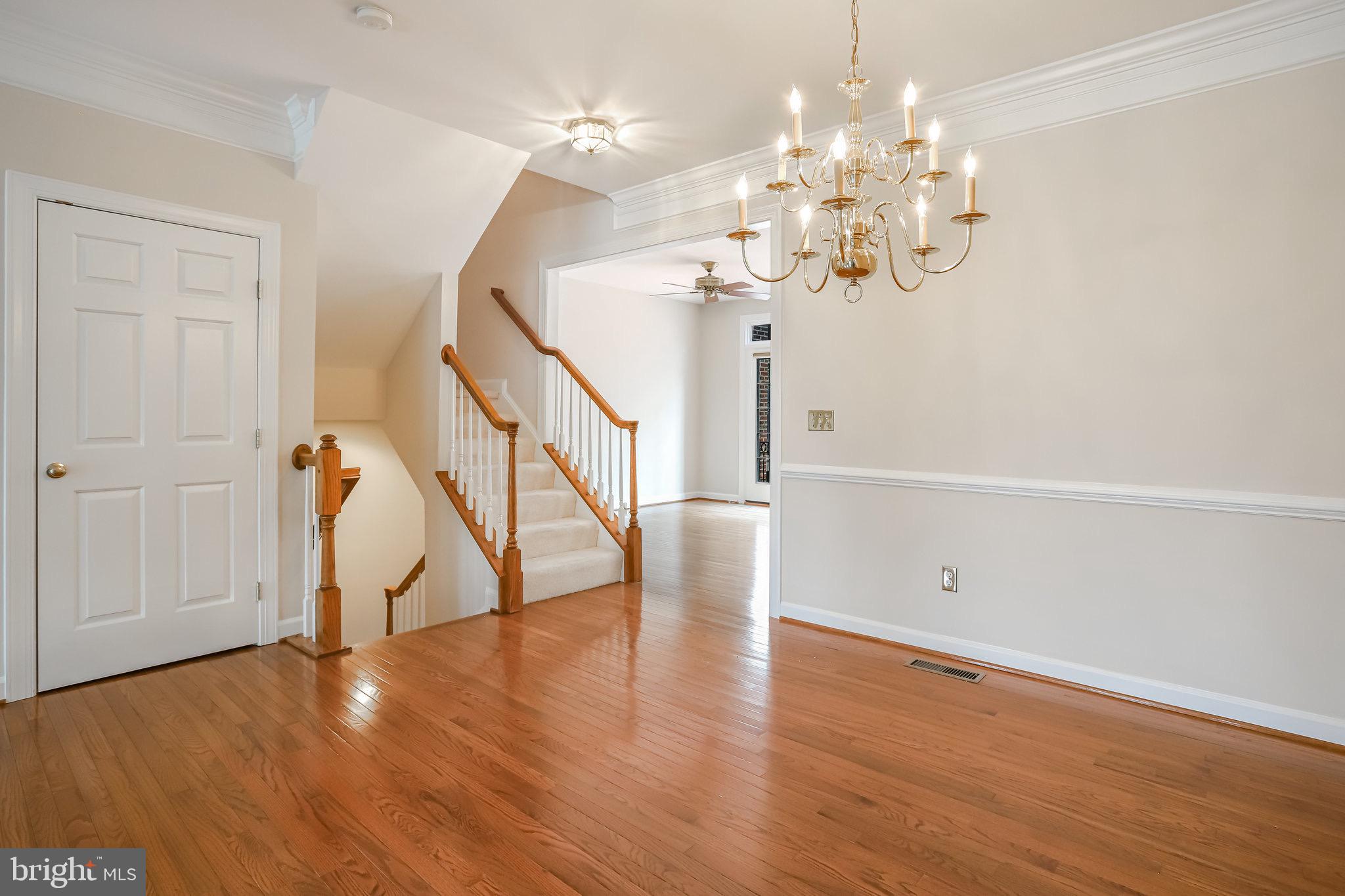 18546 Perdido Bay Terrace Leesburg, VA 20176 - Photo 11 of 57 a view of a room with wooden floor and staircase