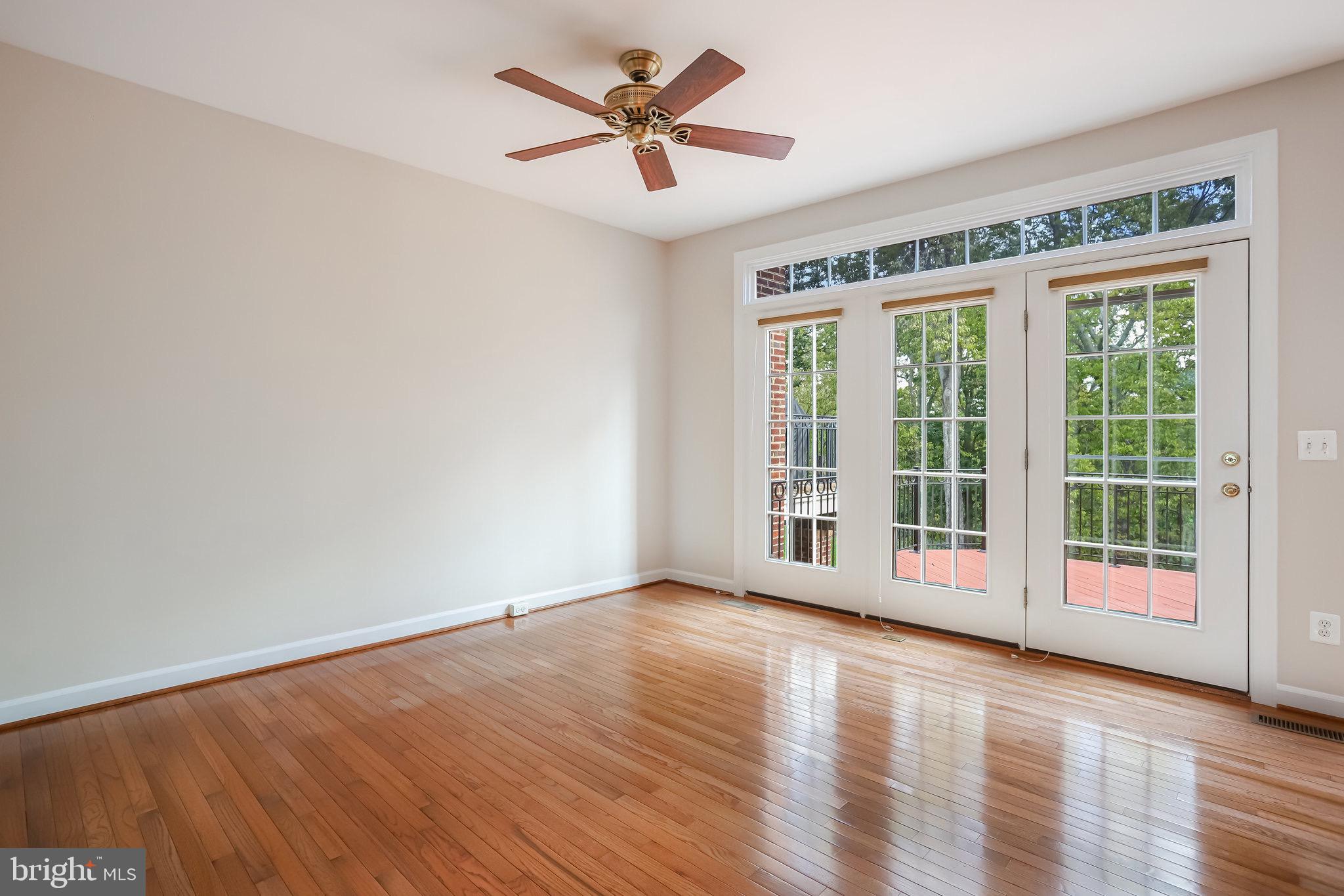 18546 Perdido Bay Terrace Leesburg, VA 20176 - Photo 15 of 57 a view of a big room with wooden floor and a chandelier fan