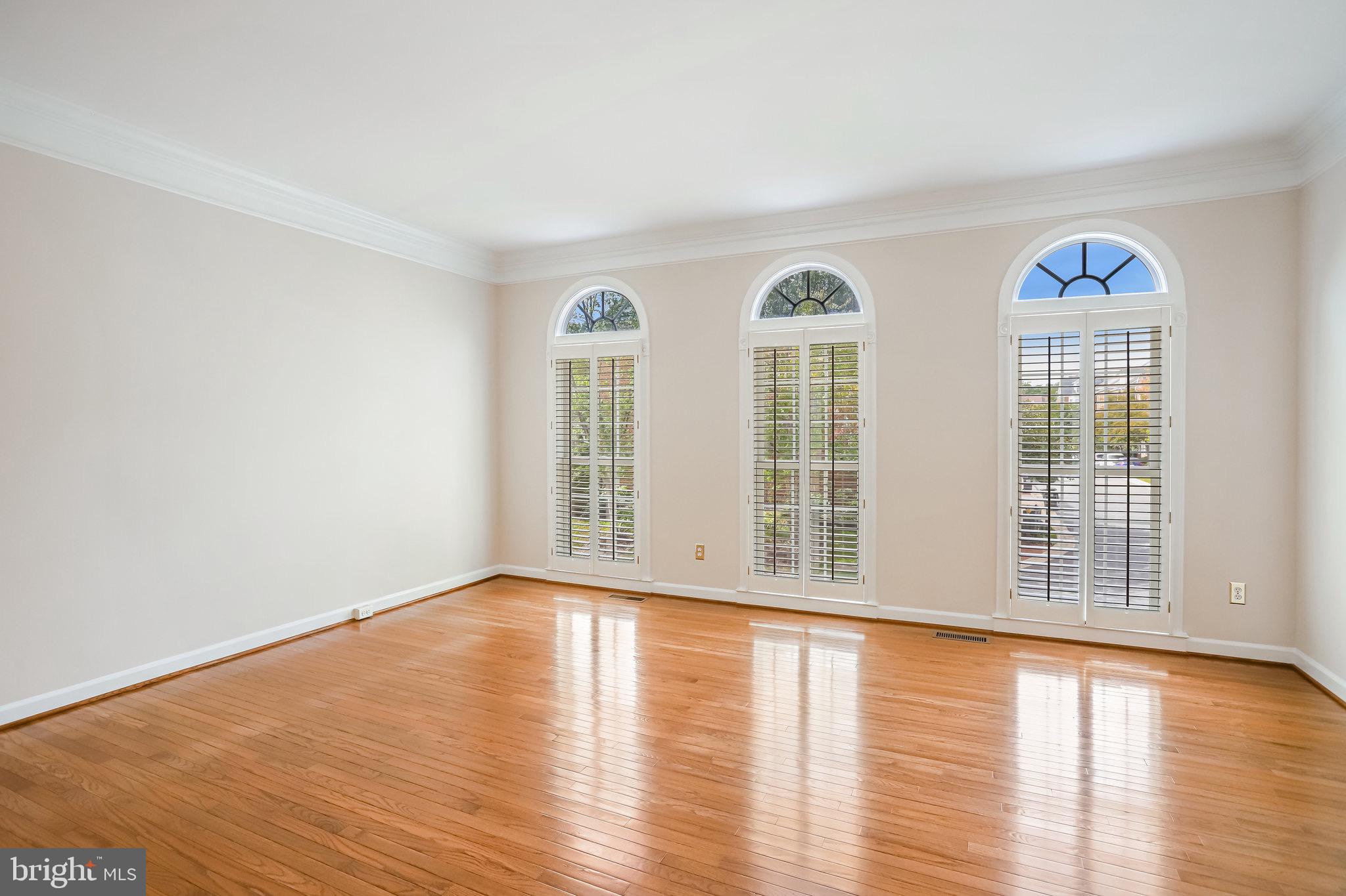 18546 Perdido Bay Terrace Leesburg, VA 20176 - Photo 6 of 57 a view of an empty room with wooden floor and a window