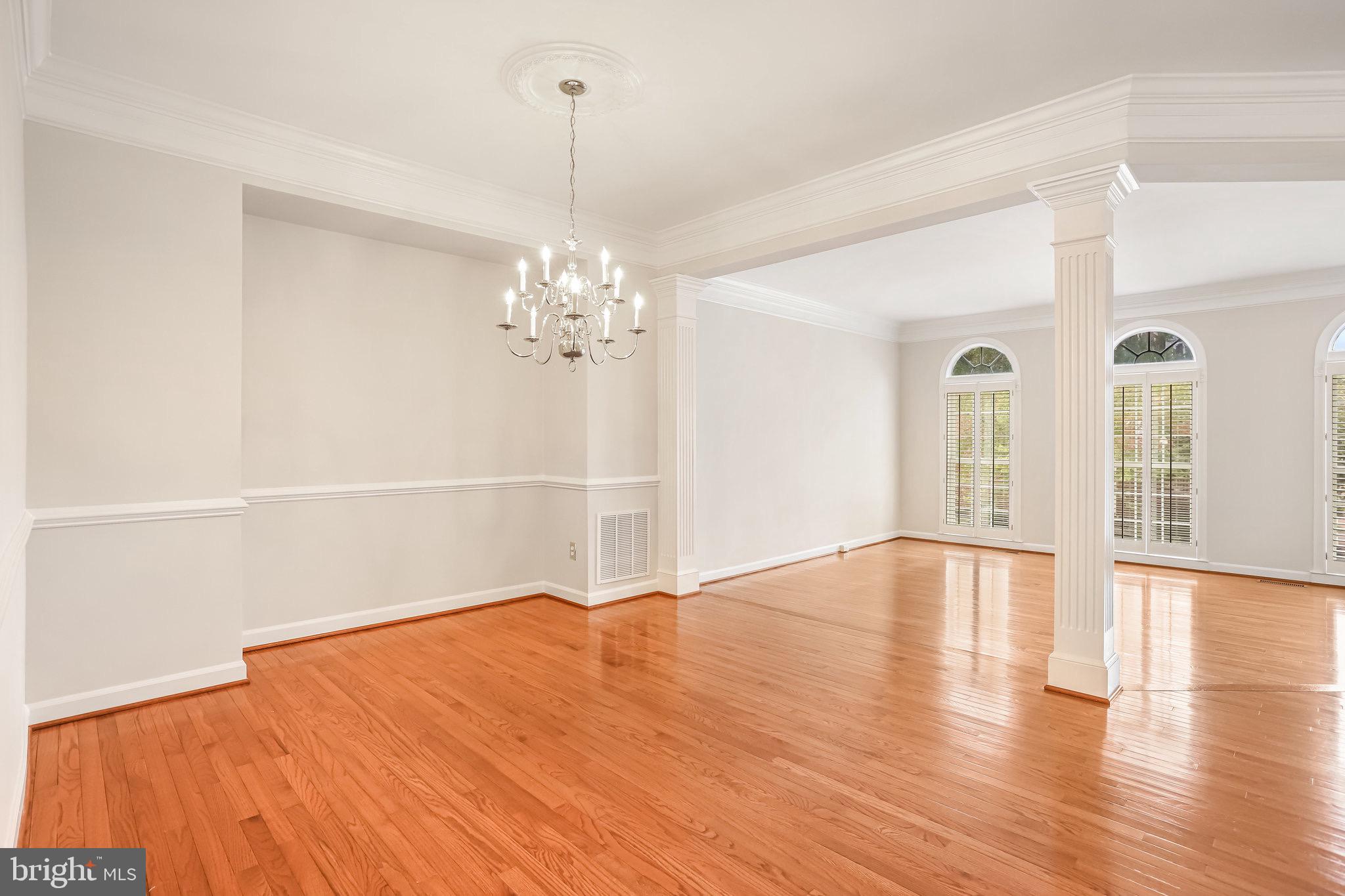 18546 Perdido Bay Terrace Leesburg, VA 20176 - Photo 9 of 57 a view of an empty room with wooden floor and a window