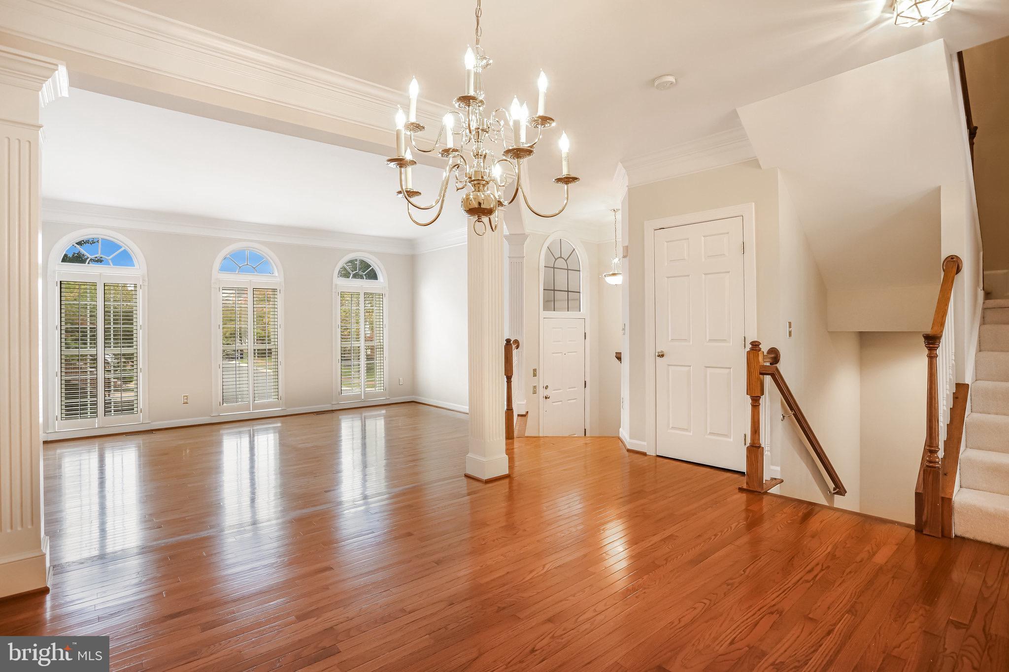 18546 Perdido Bay Terrace Leesburg, VA 20176 - Photo 10 of 57 a view of an empty room with wooden floor and a chandelier