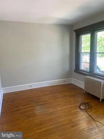 a view of a room with wooden floor and fan