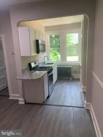 a kitchen with wooden floors and sink