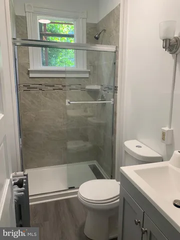a bathroom with a toilet sink and shower