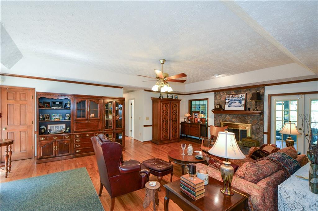 130 Hawn Road Fayetteville, GA 30215 - Photo 8 of 67 a living room with furniture a fireplace and a flat screen tv