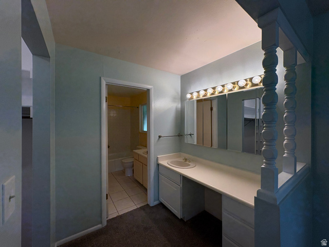 595 Meadowlark Road Orem, UT 84097 - Photo 32 of 87 Vanity area featuring a built-in countertop with an integrated sink, white cabinetry, and a full-width mirror with overhead lighting