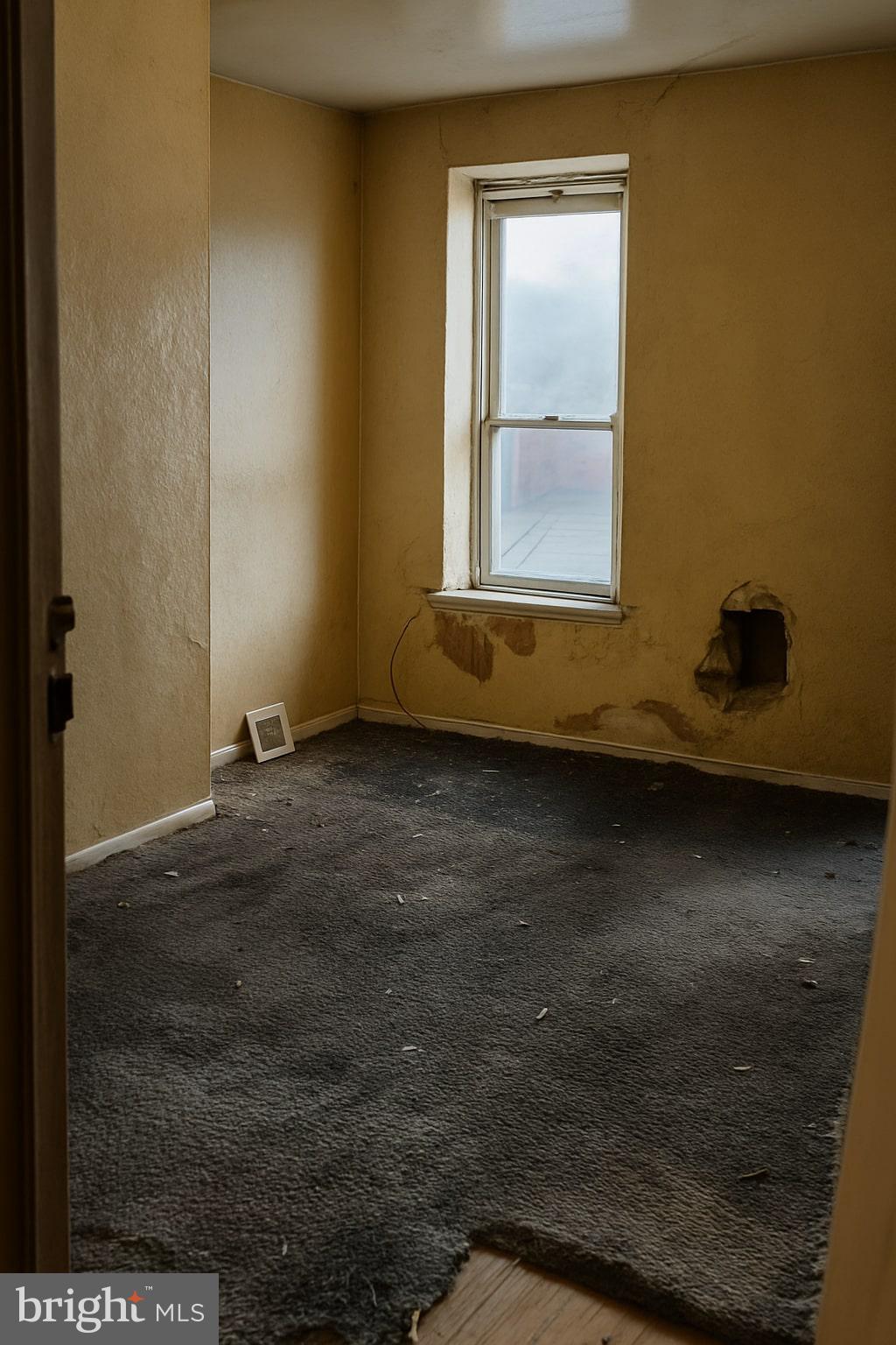 3557 North Marshall Street Philadelphia, PA 19140 - Photo 6 of 9 a view of an empty room with wooden floor and a window
