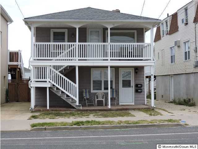 a view of a house with wooden fence