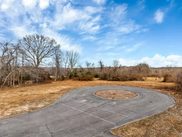 a view of a yard with snow on the road