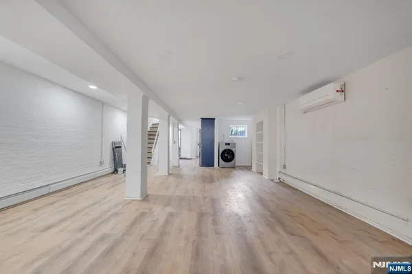 a view of an empty room with wooden floor and entryway