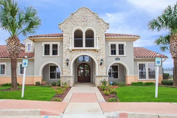 a view of a white house with a yard and plants