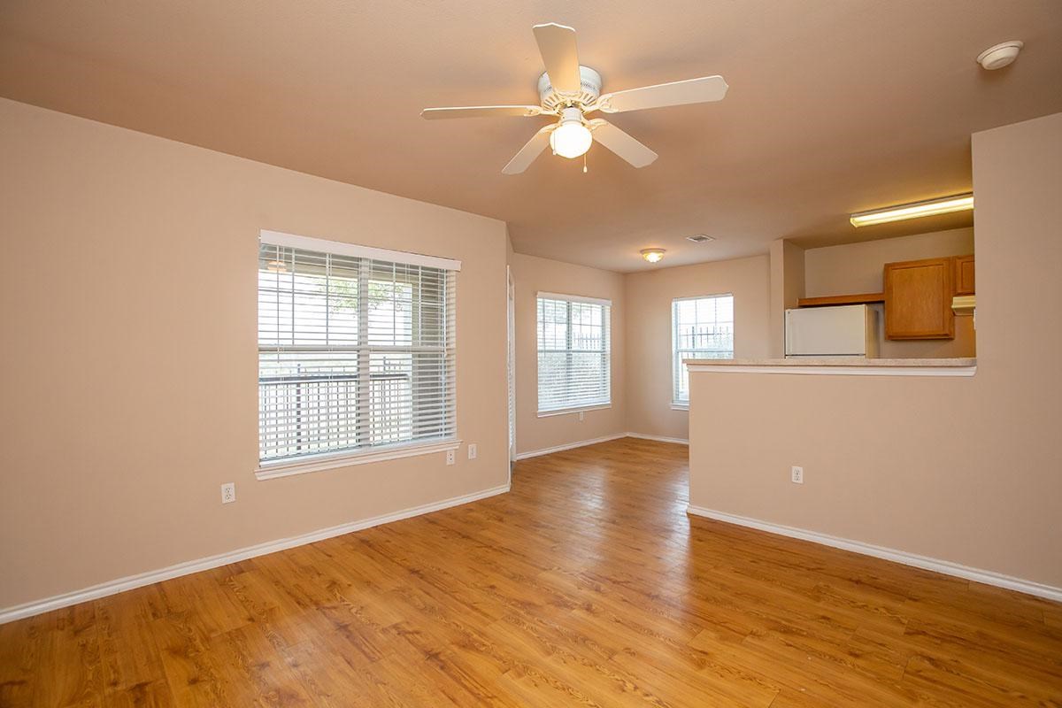 5606 St David Lane, Unit 160 Laredo, TX 78046 - Photo 4 of 6 an empty room with wooden floor and windows