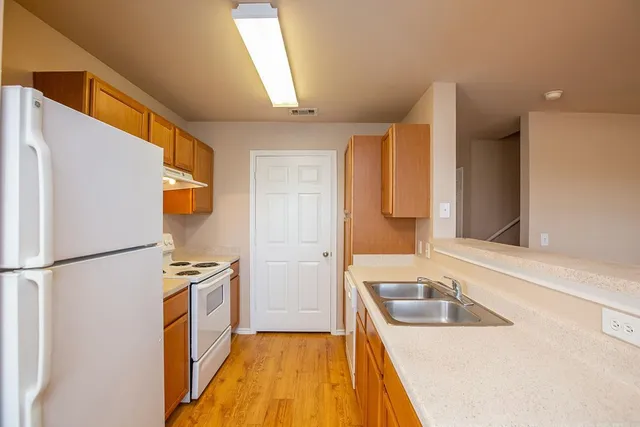 a kitchen with a refrigerator a sink and dishwasher