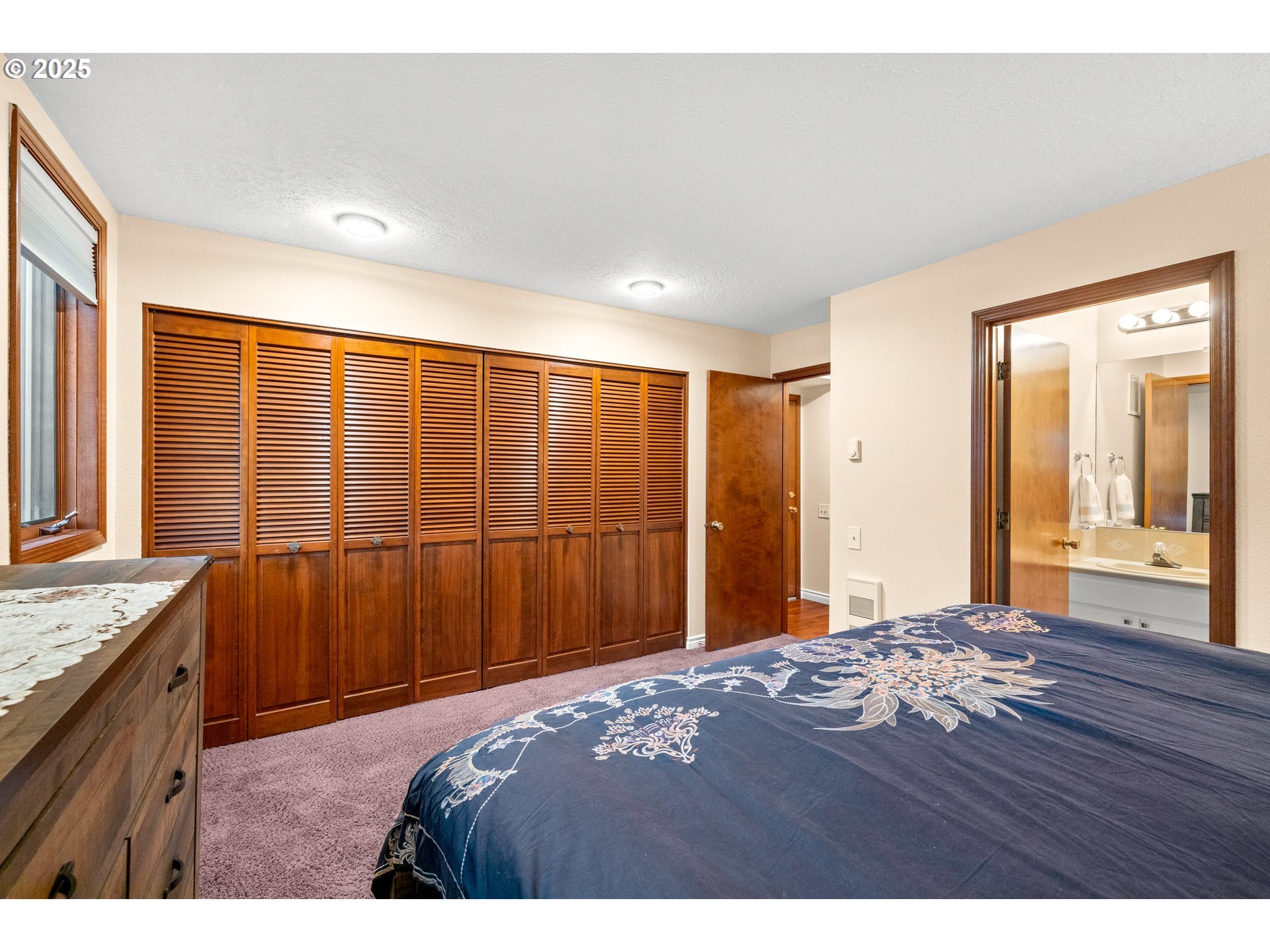 14945 Northeast Sacramento Street, Unit 34 Portland, OR 97230 - Photo 14 of 26 a bedroom with a bed dresser and a window