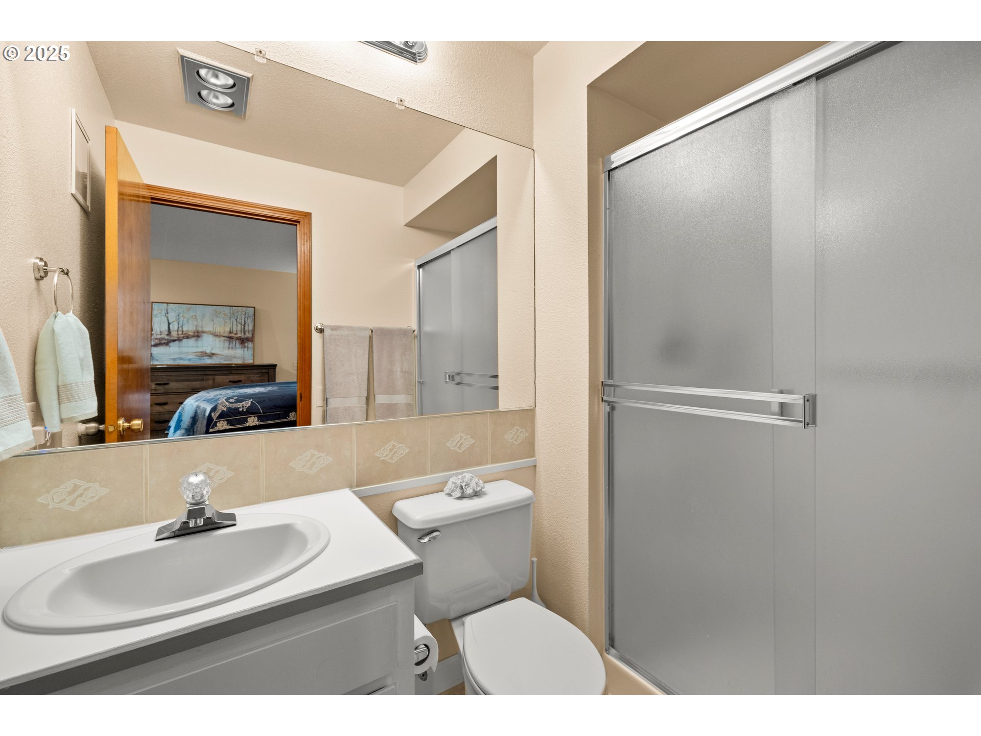 14945 Northeast Sacramento Street, Unit 34 Portland, OR 97230 - Photo 15 of 26 a bathroom with a sink toilet a mirror and shower