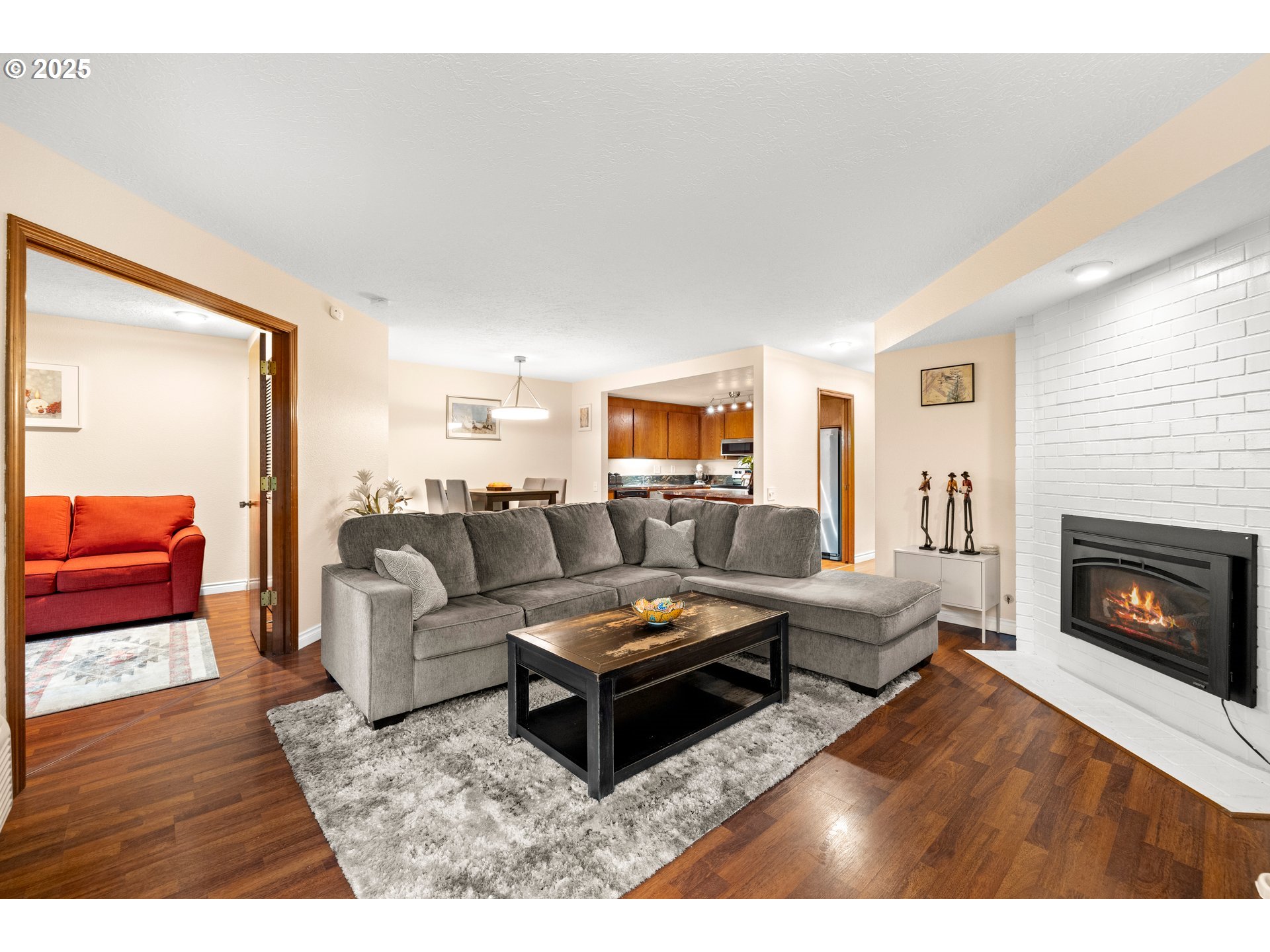 14945 Northeast Sacramento Street, Unit 34 Portland, OR 97230 - Photo 2 of 26 a living room with furniture and a fireplace