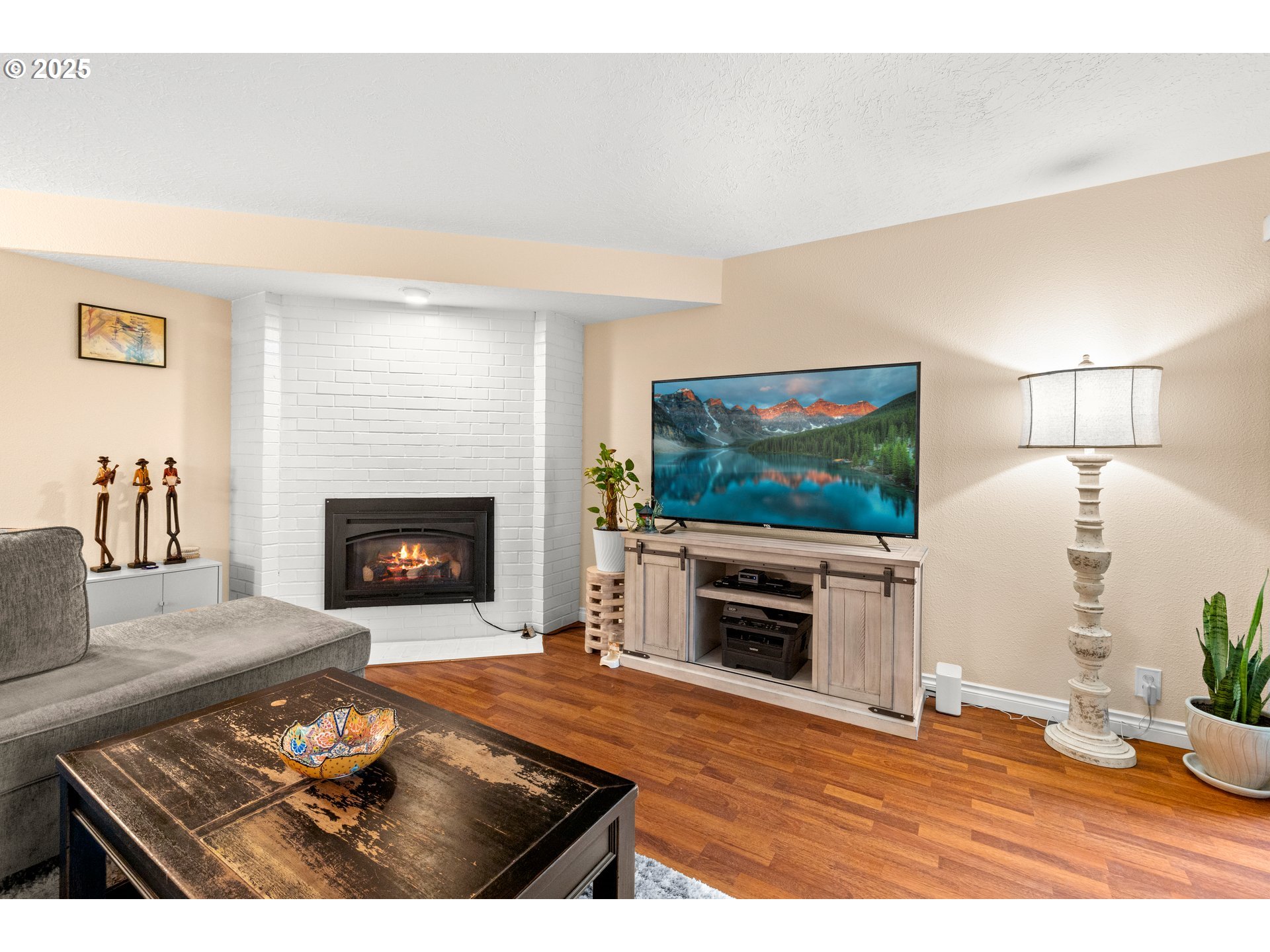 14945 Northeast Sacramento Street, Unit 34 Portland, OR 97230 - Photo 5 of 26 a living room with furniture a flat screen tv and a fireplace