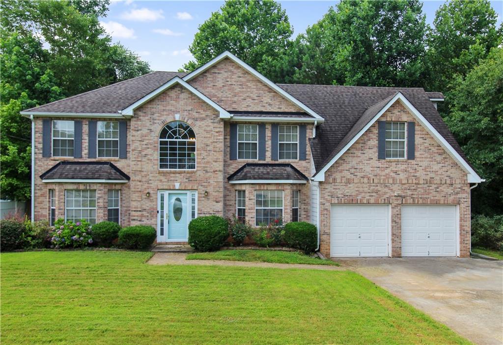 4730 Galleon Crossing Decatur, GA 30035 - Photo 1 of 1 a front view of a house with a yard and garage