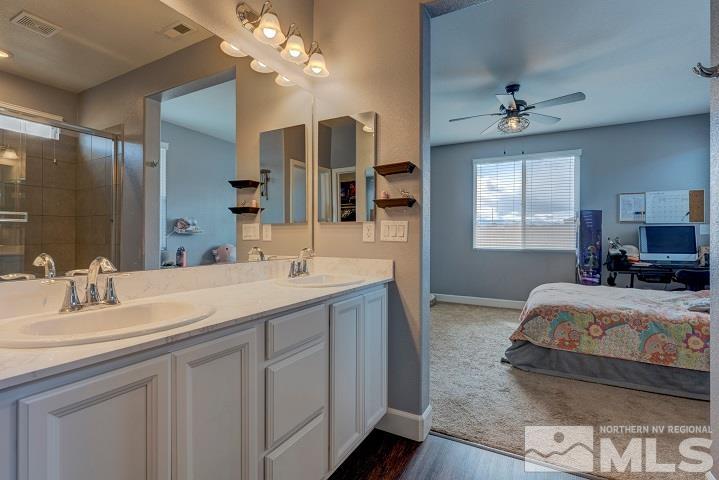 9405 Cape Drive Reno, NV 89506 - Photo 11 of 17 a en suite bathroom with a double vanity sink and a mirror
