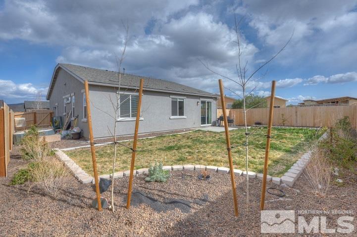 9405 Cape Drive Reno, NV 89506 - Photo 15 of 17 a view of a house with a backyard