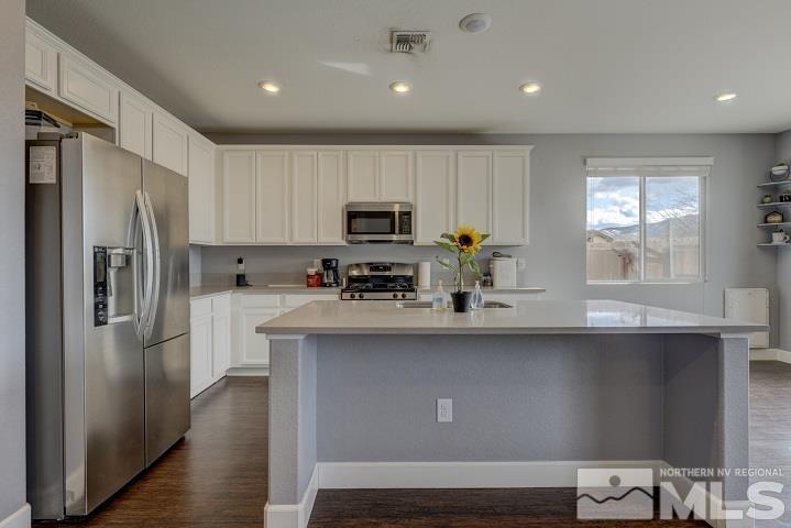 9405 Cape Drive Reno, NV 89506 - Photo 2 of 17 a kitchen with a refrigerator a sink and cabinets