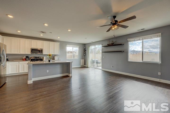 9405 Cape Drive Reno, NV 89506 - Photo 5 of 17 a kitchen with granite countertop stainless steel appliances refrigerator cabinets and a wooden floor