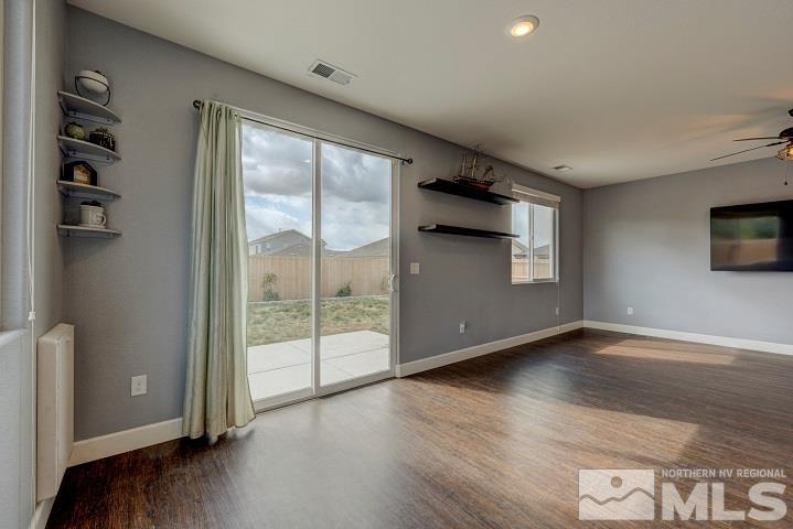 9405 Cape Drive Reno, NV 89506 - Photo 7 of 17 an empty room with wooden floor and windows