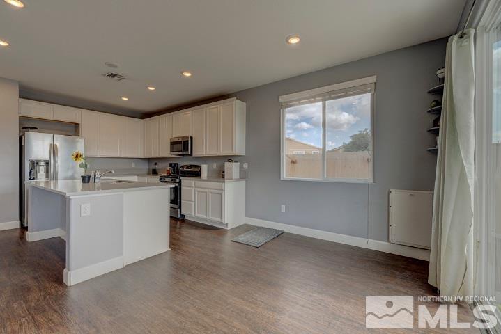 9405 Cape Drive Reno, NV 89506 - Photo 9 of 17 a kitchen with white cabinets and appliances