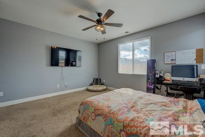 9405 Cape Drive Reno, NV 89506 - Photo 10 of 17 a bedroom with a bed and a flat screen tv