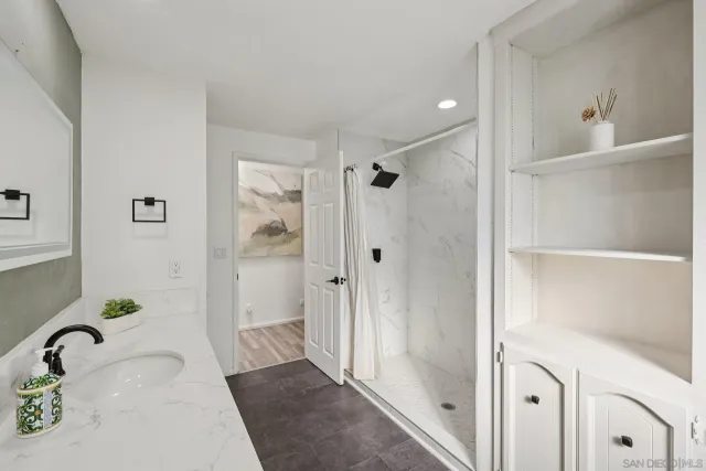 a bed sitting in a balcony next to a large window