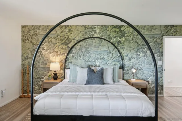 a view of a patio with table and chairs potted plants and floor to ceiling window
