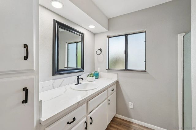 a living room with furniture and a view of kitchen