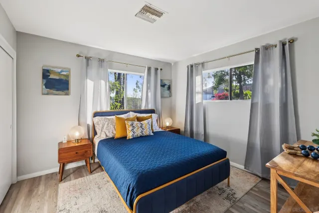 a living room with furniture and a view of kitchen