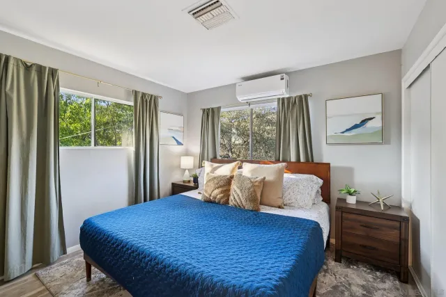 a bedroom with a bed and a tv