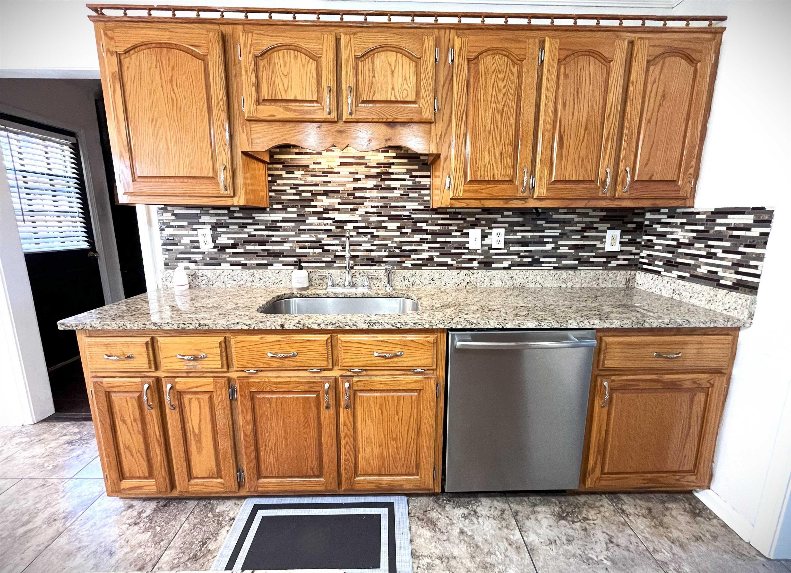 4020 Meade Lake Road Millington, TN 38053 - Photo 19 of 23 Kitchen featuring decorative backsplash, sink, stainless steel dishwasher, and light stone counters