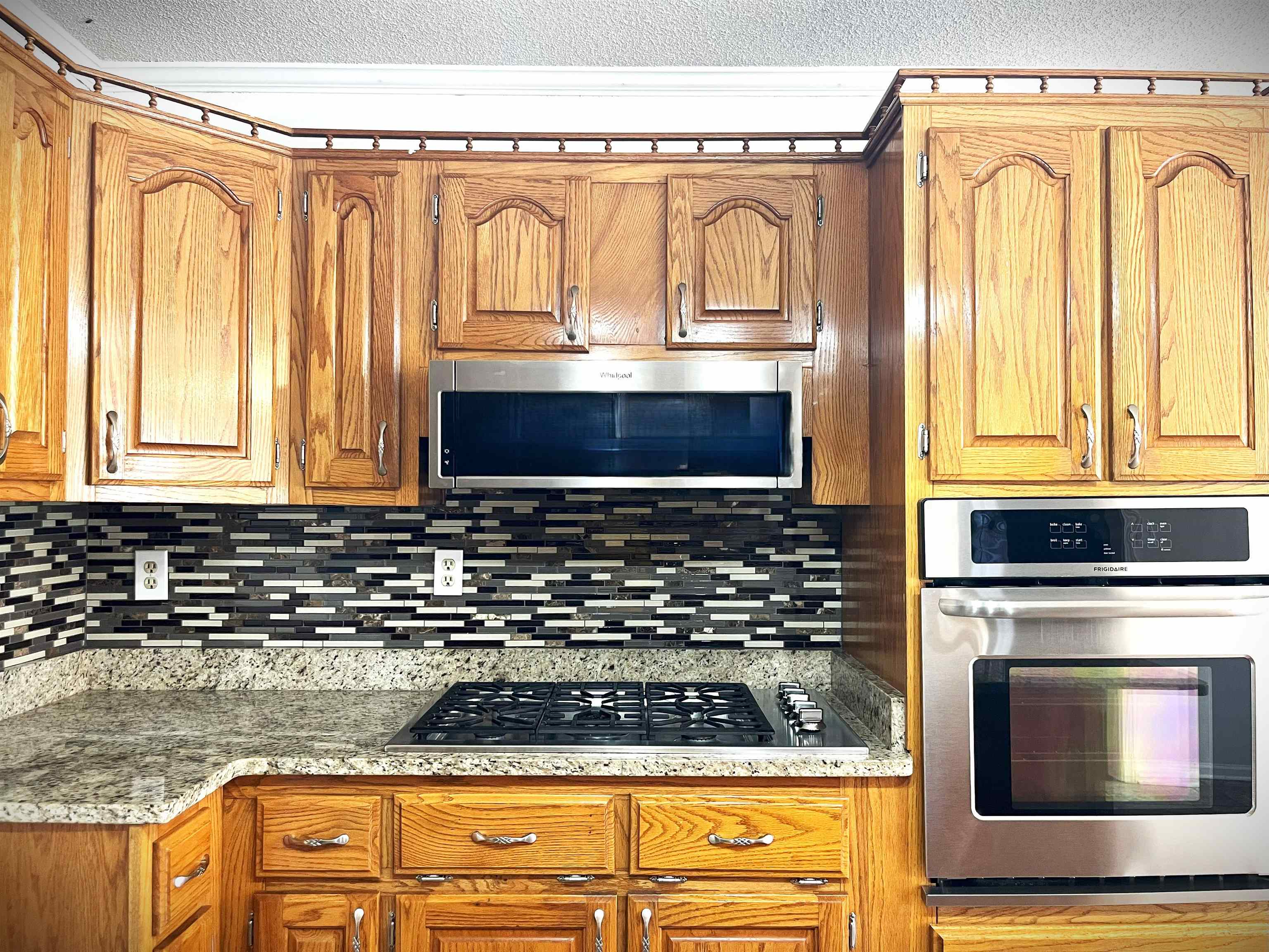 4020 Meade Lake Road Millington, TN 38053 - Photo 21 of 23 Kitchen featuring appliances with stainless steel finishes, decorative backsplash, and a textured ceiling