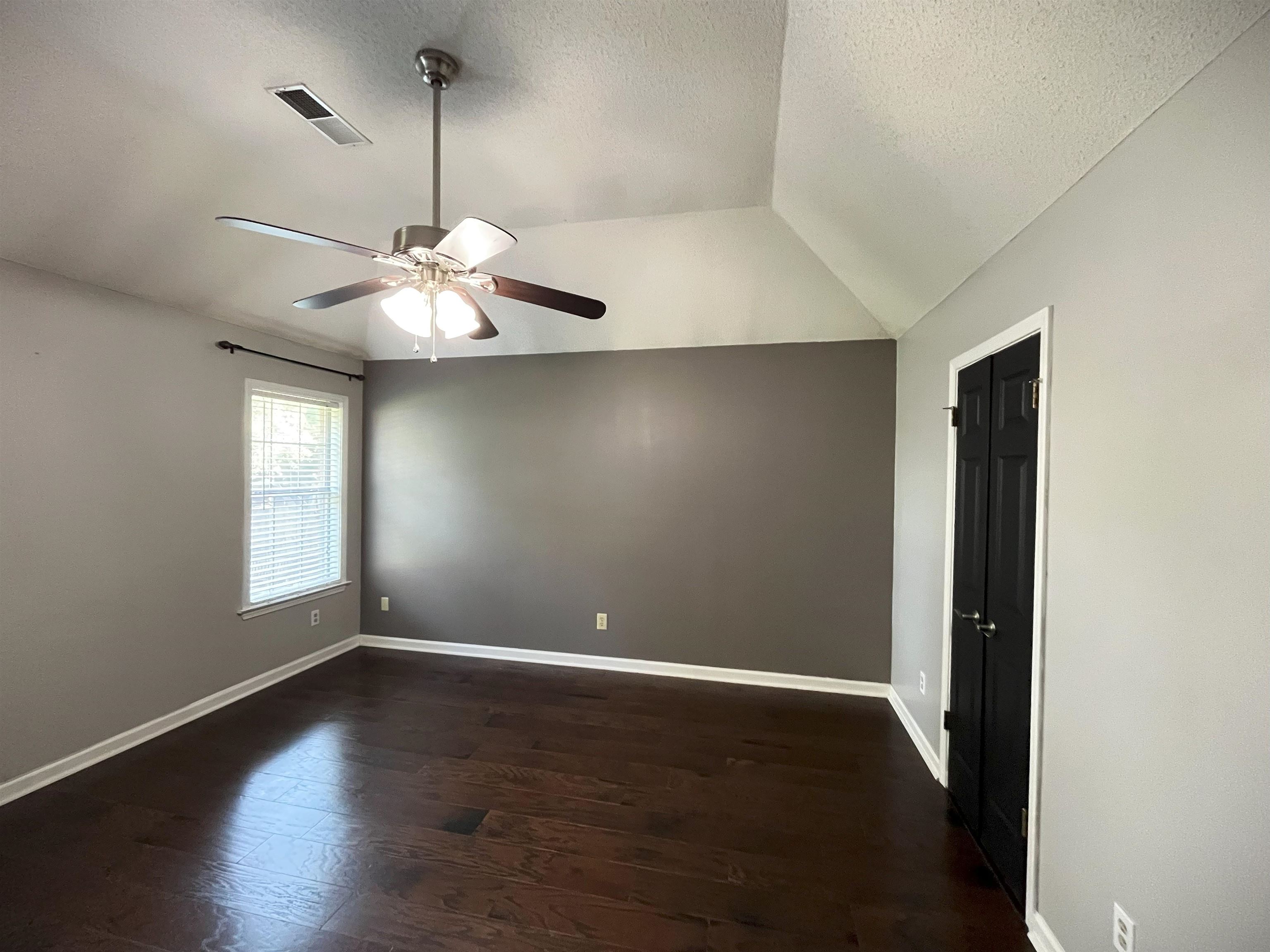 4020 Meade Lake Road Millington, TN 38053 - Photo 3 of 23 Spare room with ceiling fan, a textured ceiling, lofted ceiling, and dark hardwood / wood-style flooring
