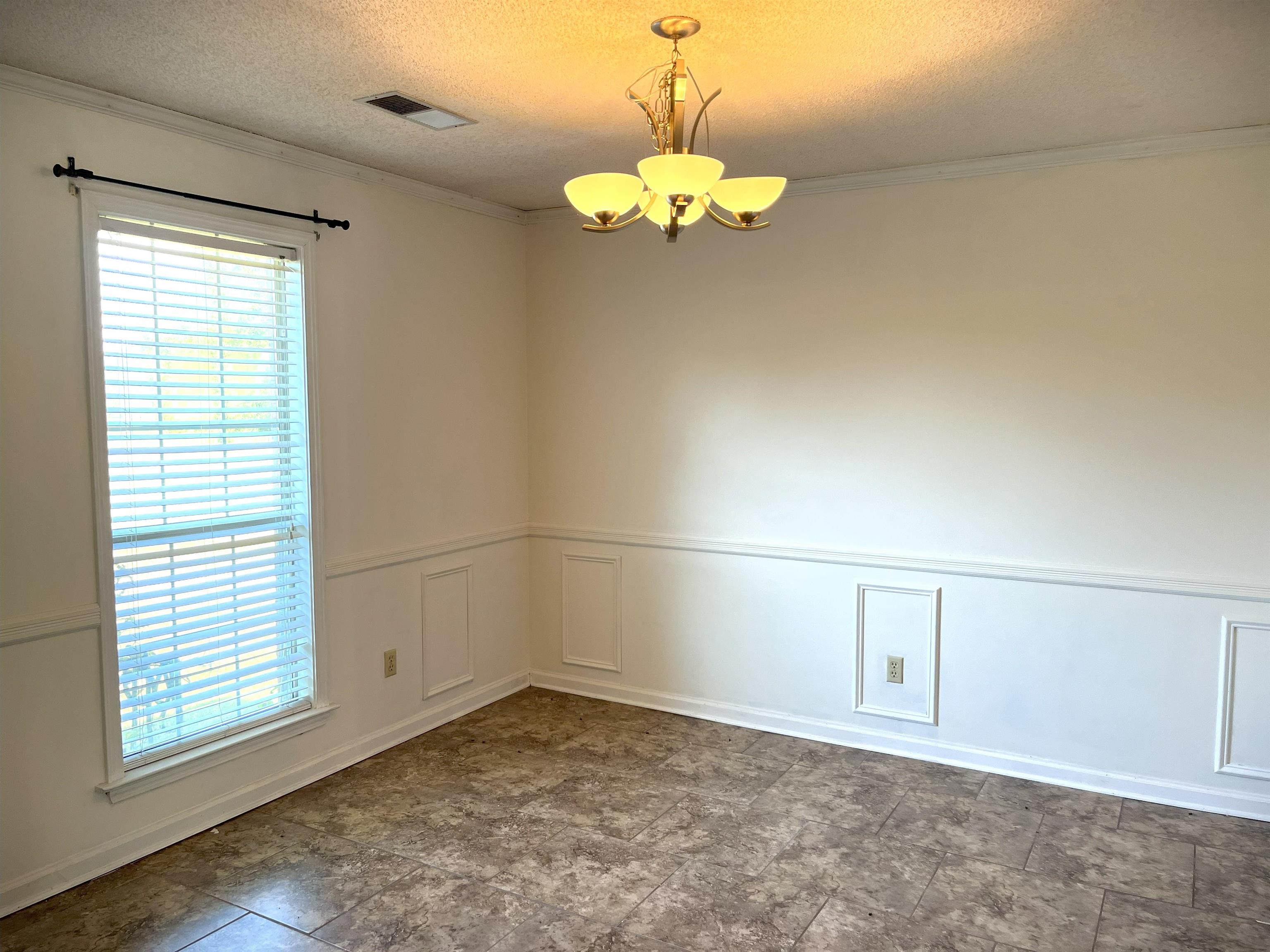 4020 Meade Lake Road Millington, TN 38053 - Photo 7 of 23 Spare room featuring ornamental molding, a chandelier, and a textured ceiling
