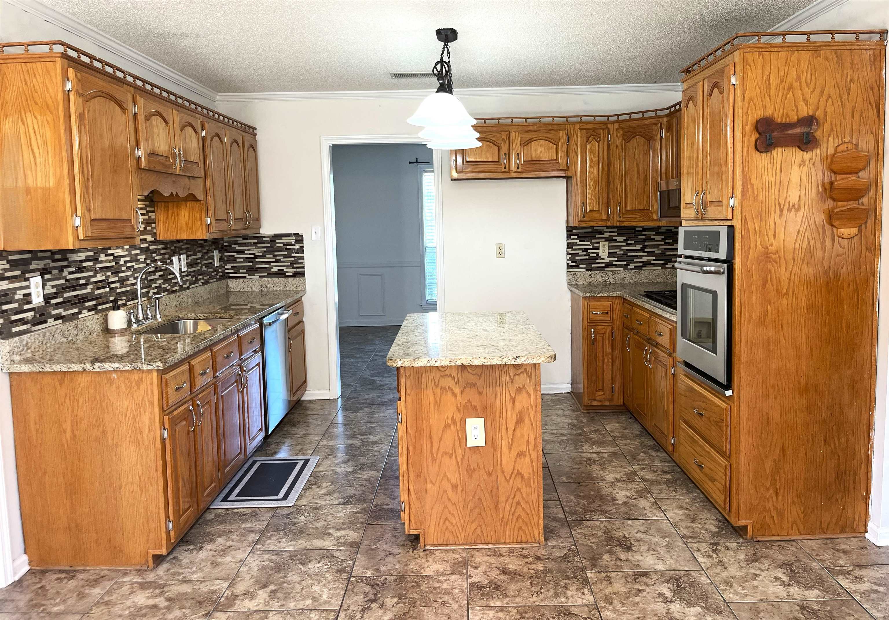 4020 Meade Lake Road Millington, TN 38053 - Photo 10 of 23 Kitchen with a kitchen island, stainless steel appliances, sink, ornamental molding, and decorative light fixtures