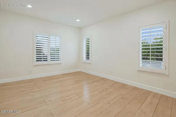a spacious bathroom with a tub sink and mirror