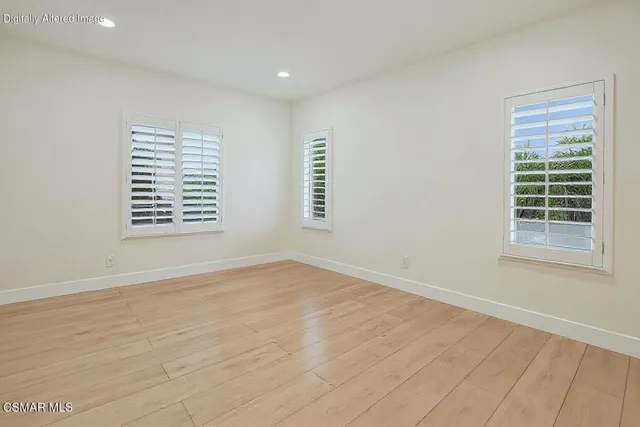 a spacious bathroom with a tub sink and mirror
